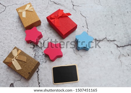 Some gift box with ribbon as a present for Christmas, new year, valentine day or anniversary on crack concrete background