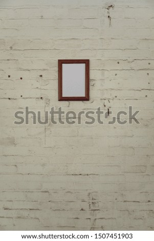Close up of a framed blank picture hanging on a wall