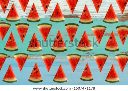 Watermelon slices cut into brightly colored triangles in a beautiful wooden floor.