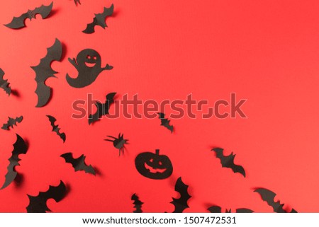 Halloween paper decorations on red background. Halloween concept. Flat lay, top view, copy space