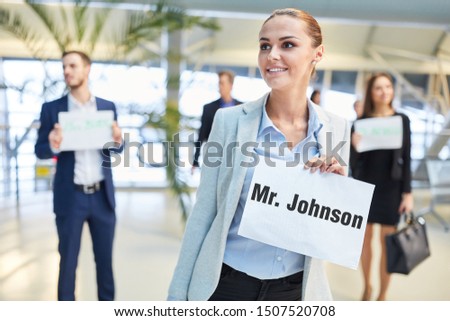 Reception of travelers at the airport with sign by group