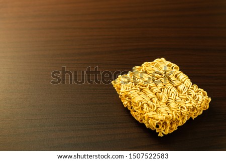 Raw instant noodles on a wooden desk.