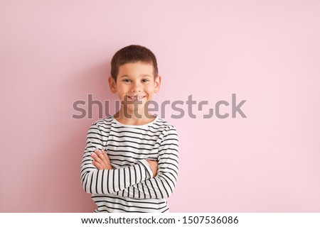 Portrait of happy little boy on color background