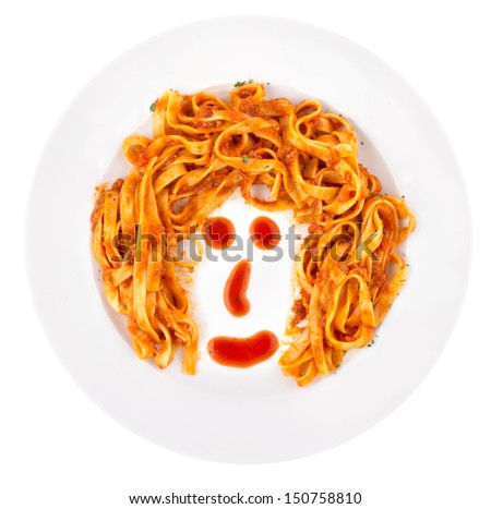 Tagliatelle Bolognaise served and arranged in a funny way representing cartoon face.