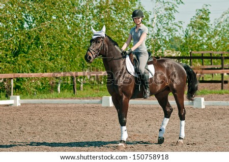 riding young woman portrait on horse in outdoor Royalty-Free Stock Photo #150758918