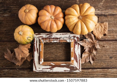 Autumn flat lay with pumpkins on wooden table