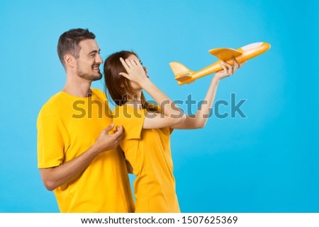 man and woman in yellow t-shirts concept flight happiness leisure lifestyle