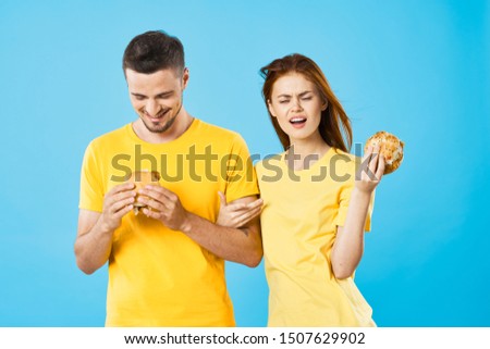 Cheerful man and woman fast food diet lifestyle 
