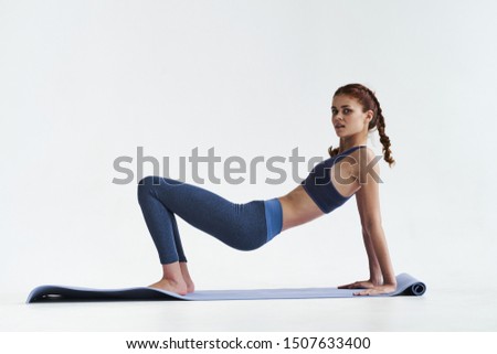 Slender figure yoga asana meditation woman sportswear and fitness mat