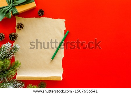 Letter to Santa Claus concept. Paper on red background with New Year decoration top view mockup space for text