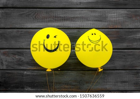 Happiness emotion. Yellow balloon with smile on blue background top view