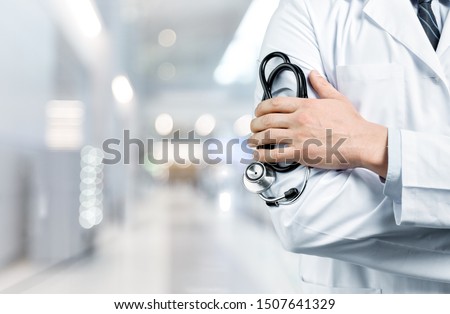 Doctor with a black stethoscope on hospital background Royalty-Free Stock Photo #1507641329