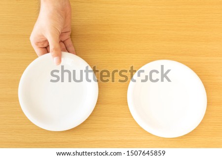 Male hand serving a plate