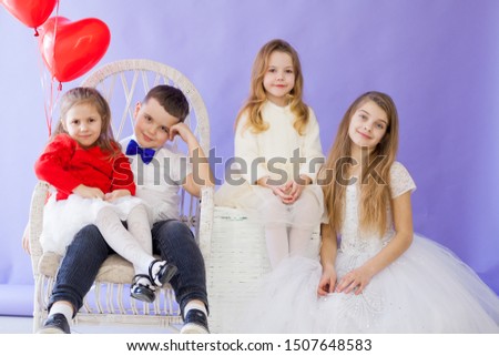 Girl's friends and boy sit with balloons