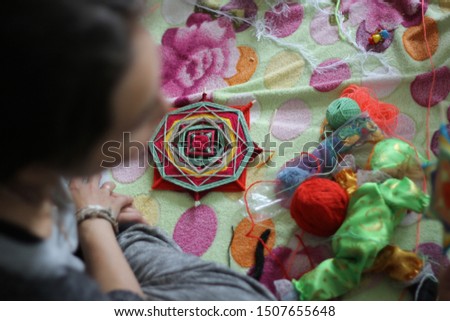 Native American Mandala on a Colored Bedspread. needlework in the women's circle in the home workshop