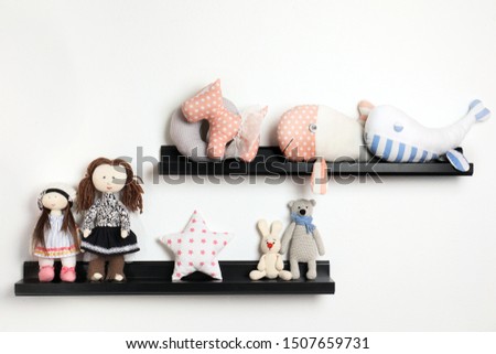 Different stuffed toys on shelves in child room