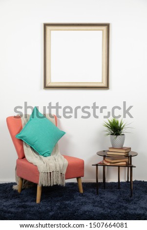Blank picture in a frame hanging on the wall of a furnished domestic sitting room