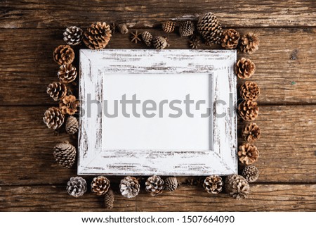 Autumn flat lay with photo frame on wooden table