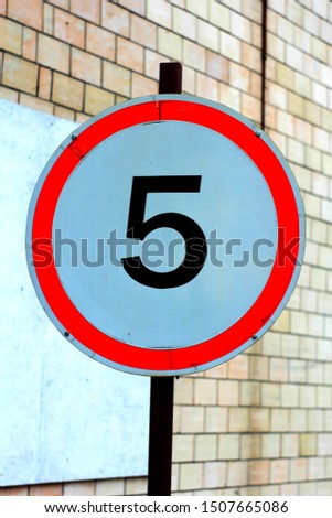 Road sign with 5 number on blur background, speed limitation, Five mph speed limit sign in UK, isolated on white. 