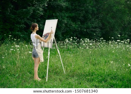 woman easel painter paints canvas beauty