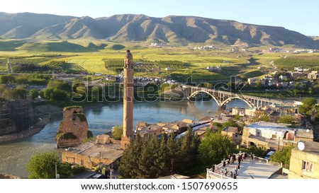 Panoramic view of the Old Tigris Bridge, Castle and minaret in the city of Hasankeyf, Turkey, Batman, Mardin Province Royalty-Free Stock Photo #1507690655