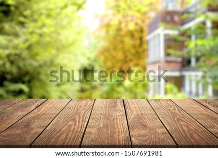 Blurred abstract green bokeh and wooden table background.