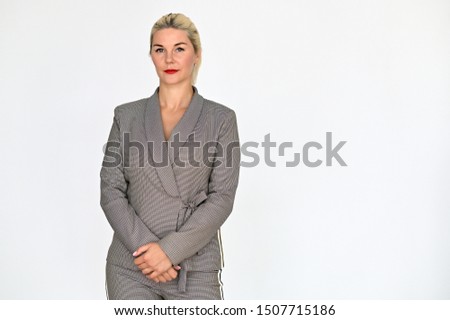 Portrait of a pretty caucasian woman manager with blond hair in a business suit on a white background. It stands right in front of the camera, with emotions in various poses.