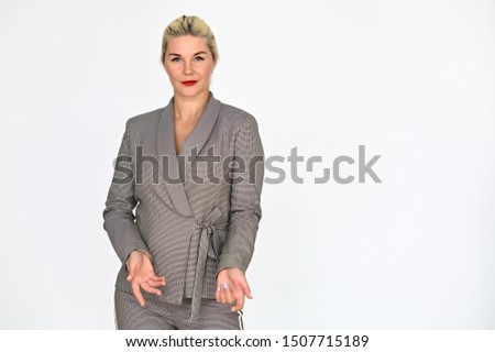 Portrait of a pretty caucasian woman manager with blond hair in a business suit on a white background. It stands right in front of the camera, with emotions in various poses.