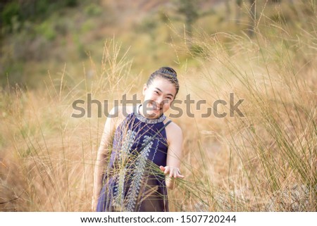 Close up beautiful smile of young asian woman at field.
 