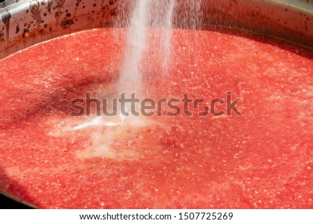 Hot boiling tomato sauce in a saucepan on the stove