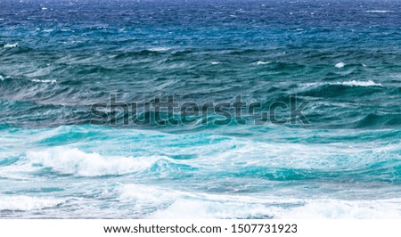 Blue stormy shore water of Mediterranean Sea with waves, panoramic background photo taken from coast of Cyprus island