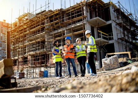 Four construction workers having meeting,stock photo