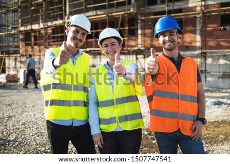Three construction workers having meeting,pose for the photographer,stock photo