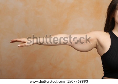 Stretched out arm of a caucasian lady. Saggy muscle and fat is s Royalty-Free Stock Photo #1507769993