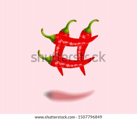 A spice themes or social issues. An alternative hashtag as a peppers on coral background. Negative space to insert your text. Modern design. Contemporary art. Creative conceptual and colorful collage.