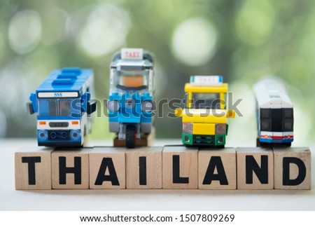 Miniature toy Thai public service car put on wooden blocks word of Thailand. Concept of car service at Bangkok Thailand