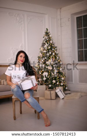 Happy New Year and a beautiful girl with gifts,
Merry Christmas with a charming brunette woman
