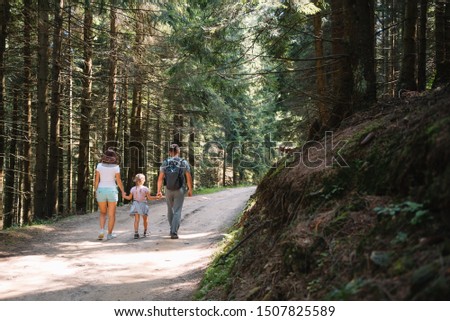 Young family with child resting on a forest