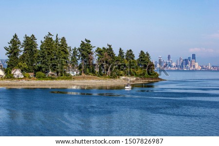 Bainbridge island and downtown of Seattle in the distance Royalty-Free Stock Photo #1507826987