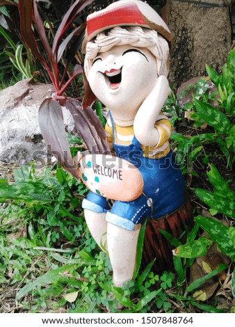 Natural happy doll welcome in the garden
