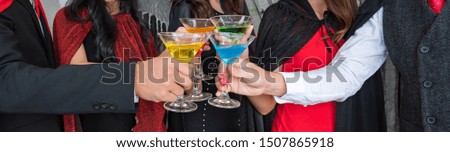 Halloween party, Group of young people celebrating a holiday party with glasses of nectar