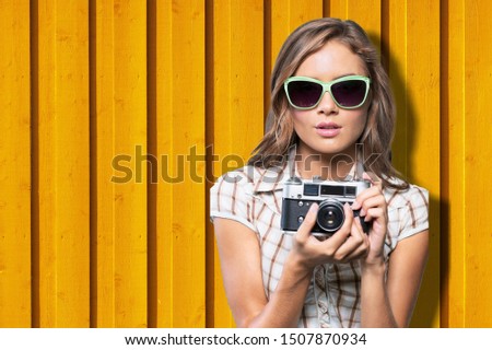 Portrait of positive woman using retro equipment for taking pictures during summer trip for exploring Chaouen berber culture, happy female tourist with technology enjoying international vacations