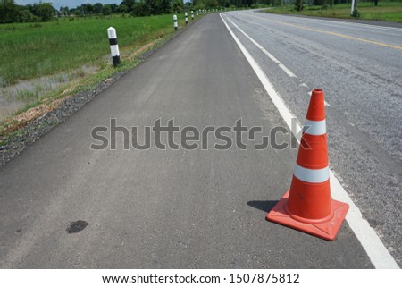 Red rubber cone placed on the road to ensure safety