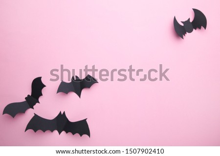 Halloween paper decorations on pastel pink background. Halloween concept. Flat lay, top view, copy space