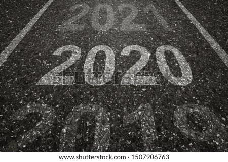 Asphalt road with 2020 letters painted on the surface. Concept for success in the future goal and passing time. Happy new year