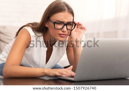 Poor Eyesight. Girl Looking At Laptop Having Near Vision Problem At Home. Selective Focus Royalty-Free Stock Photo #1507926740