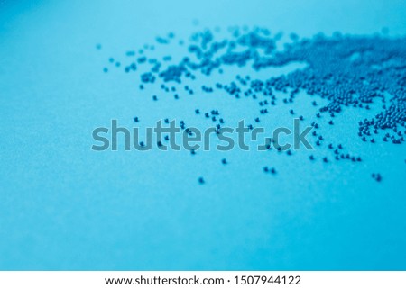 sprinkle of blue balls on a blue background