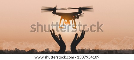 Drone quad copter with high resolution digital camera on the sky mountain and city background.