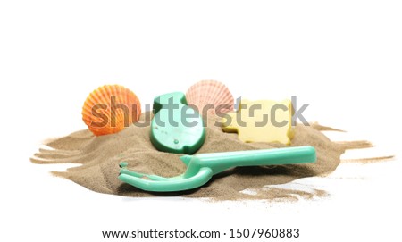 Beach toys for kids, plastic tools in sand pile with seashells isolated on white background