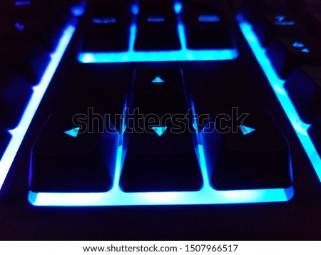 Arrow keys on colorful backlit gaming keyboard.